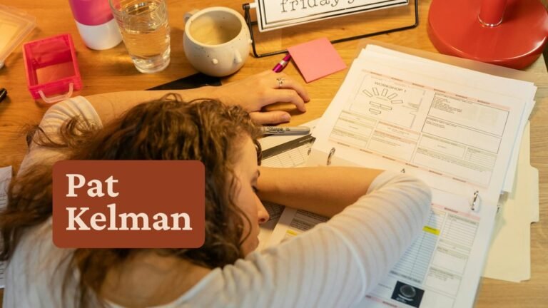 Woman overwhelmed at desk with papers — ADHD coaching niche